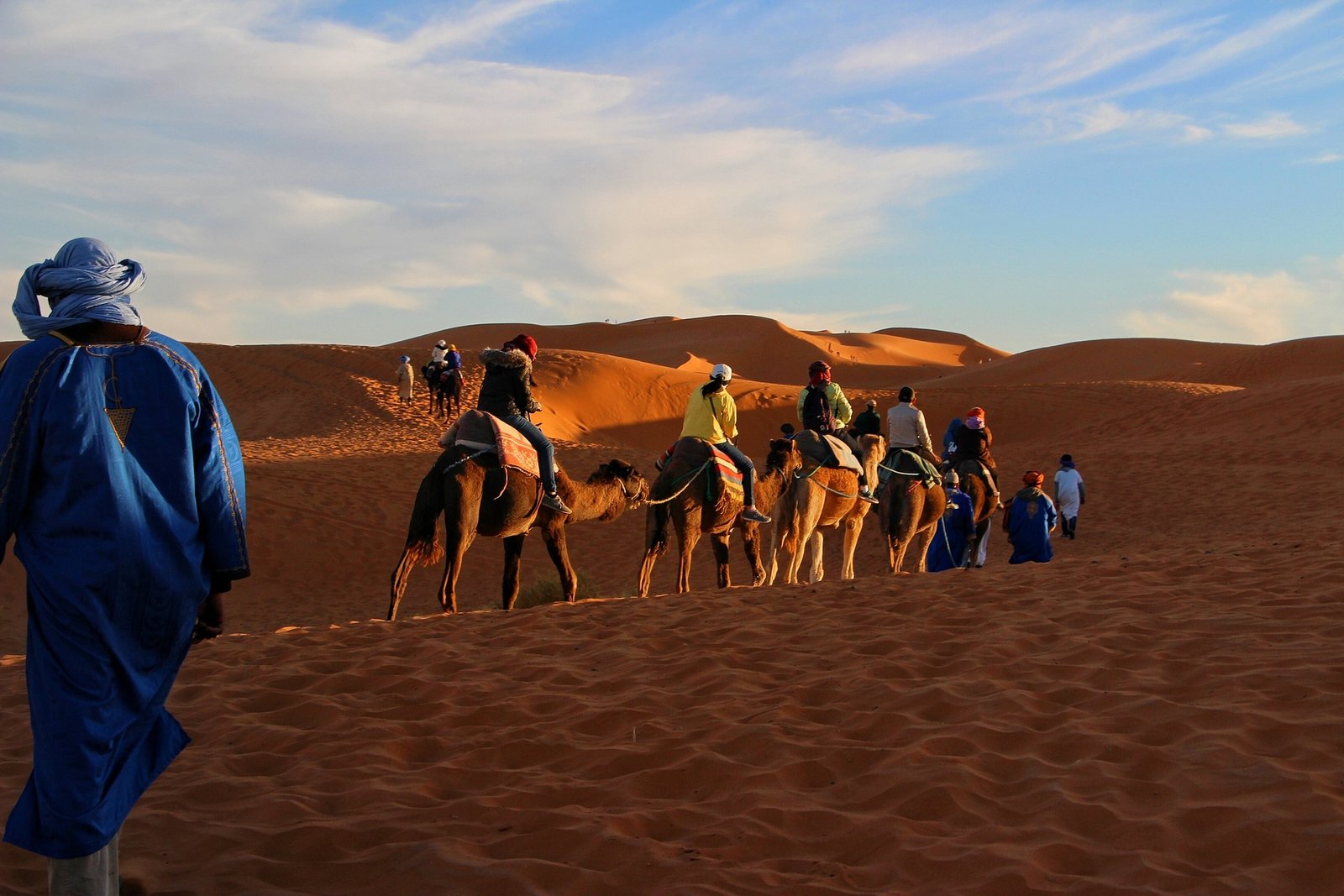 Children riding camels in the golden Sahara Desert during Morocco family holiday package morocco