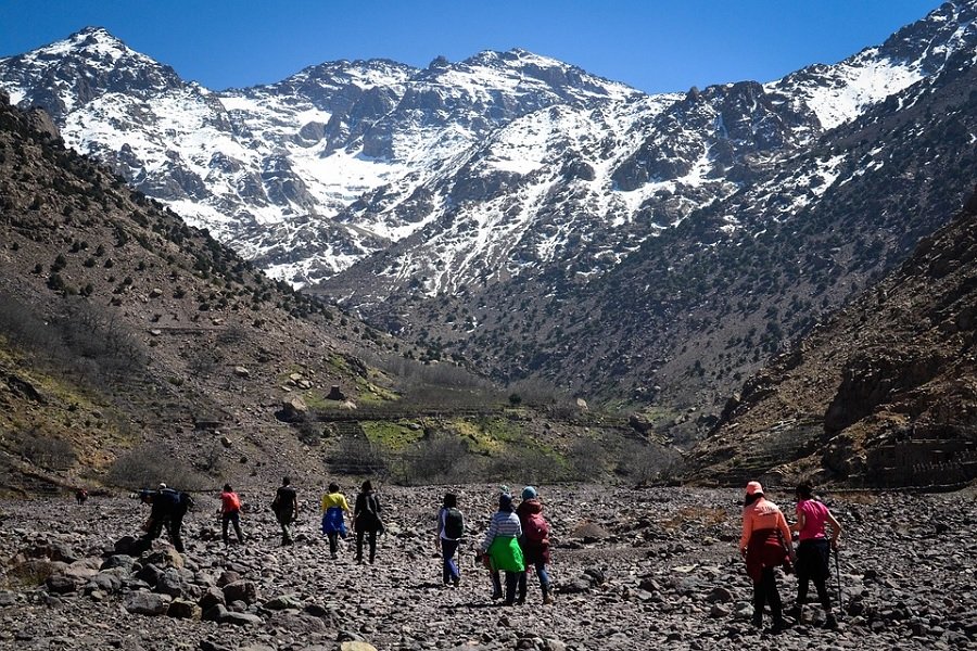 Hikers trekking Toubkal peak in Atlas Mountains, Morocco