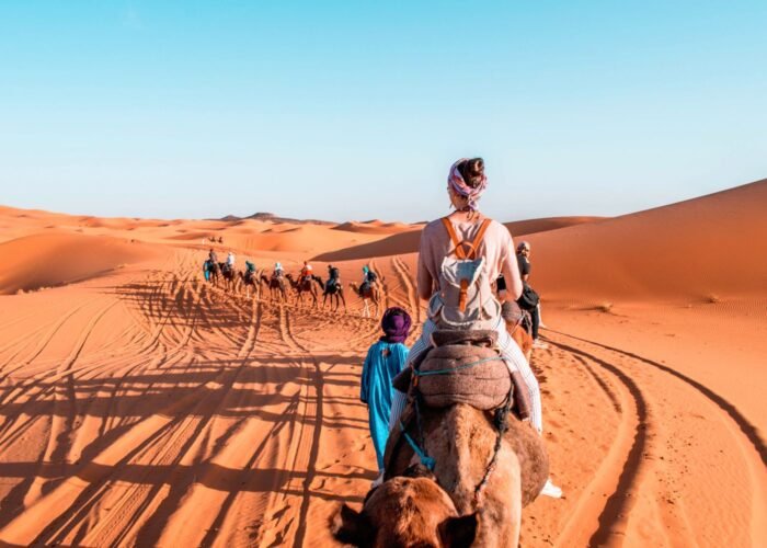 Morocco Desert Tour – camel trekking in Sahara desert dunes at sunset”