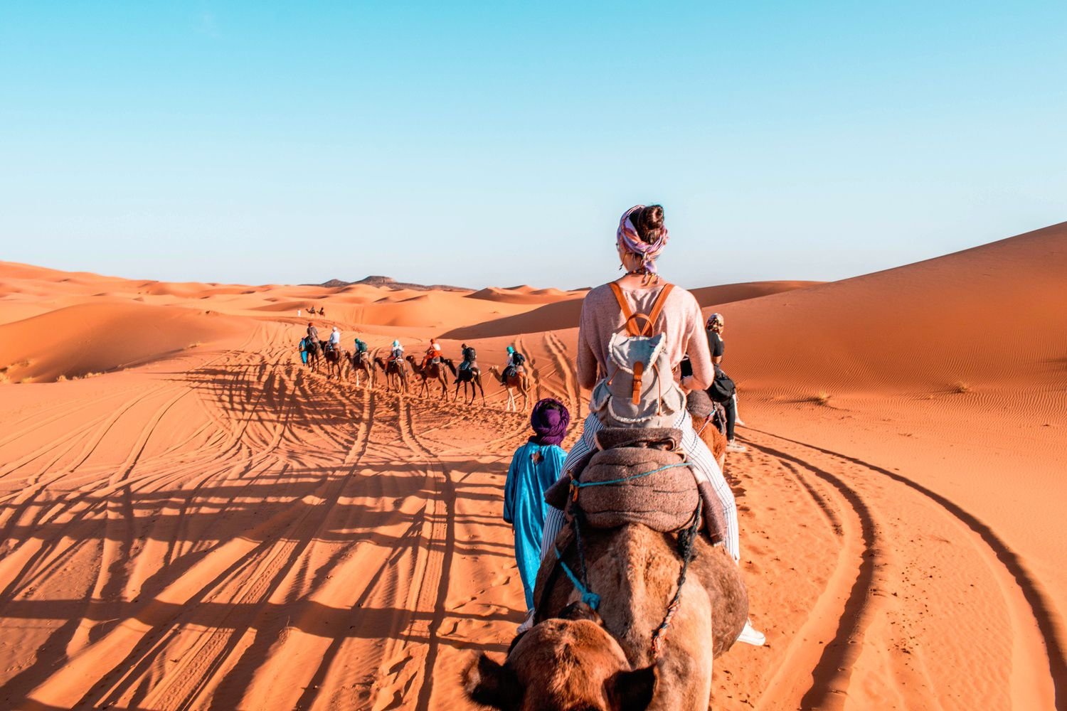 casa 2 Morocco Desert Tour – camel trekking in Sahara desert dunes at sunset”