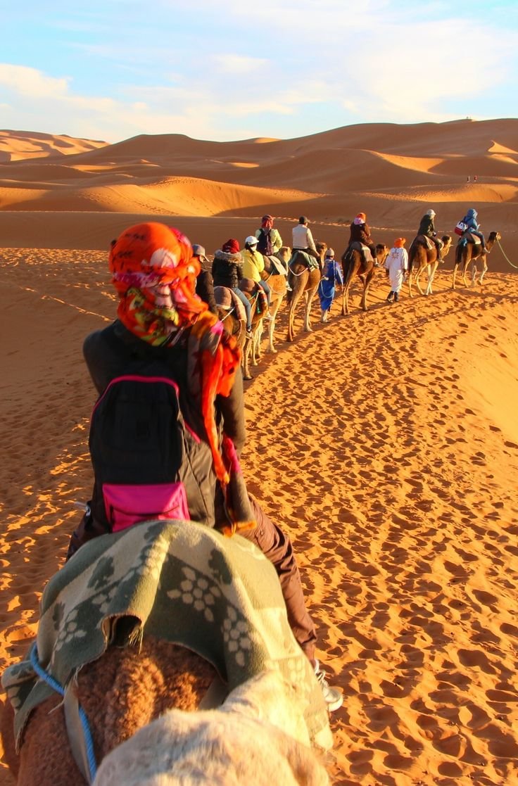 Camel riding at sunset in the Sahara Desert Morocco, part of our package Morocco tour 2026. morocco 7 day private tour package