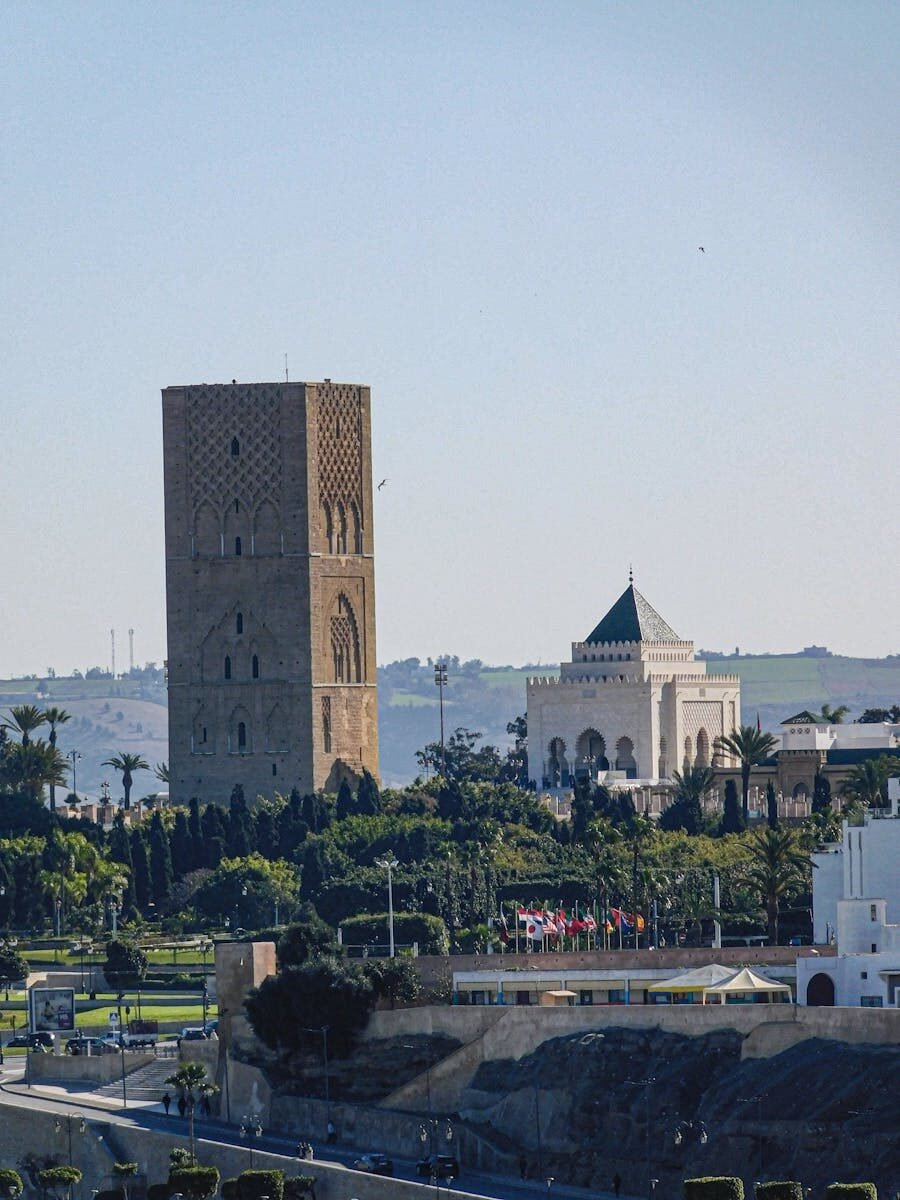 View of Hassan Tower and Mausoleum of Mohammed V in Rabat, Morocco under a clear sky.