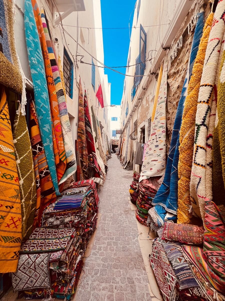 Authentic Moroccan rugs displayed in a Marrakech souk
